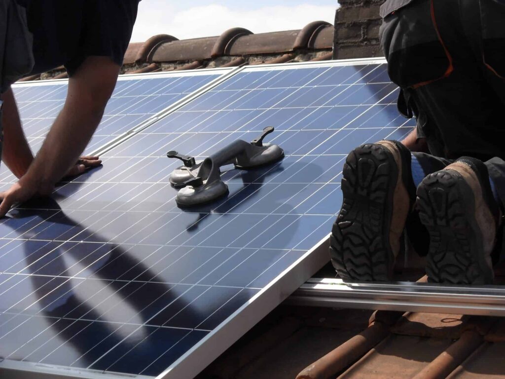 workers installing solar panels