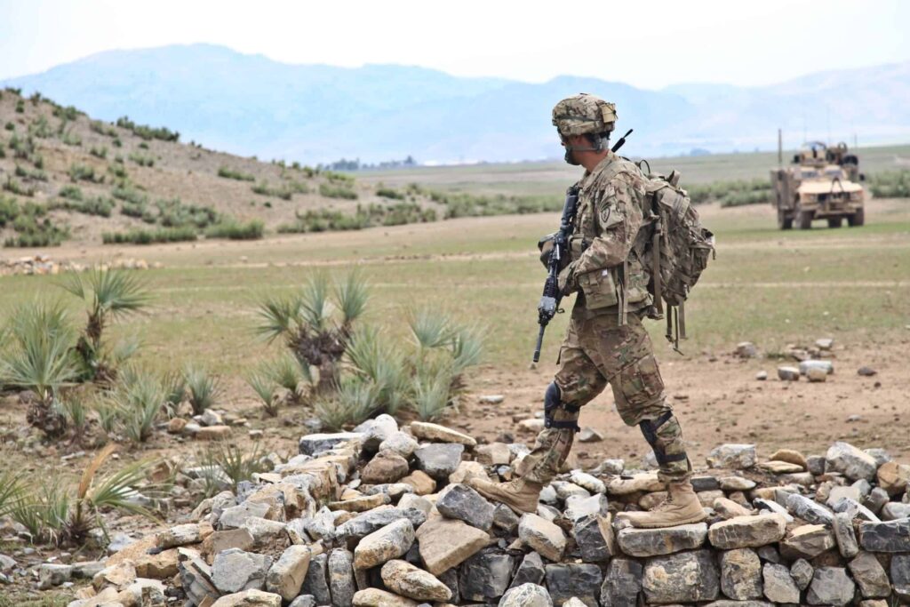 solider walking on rocks