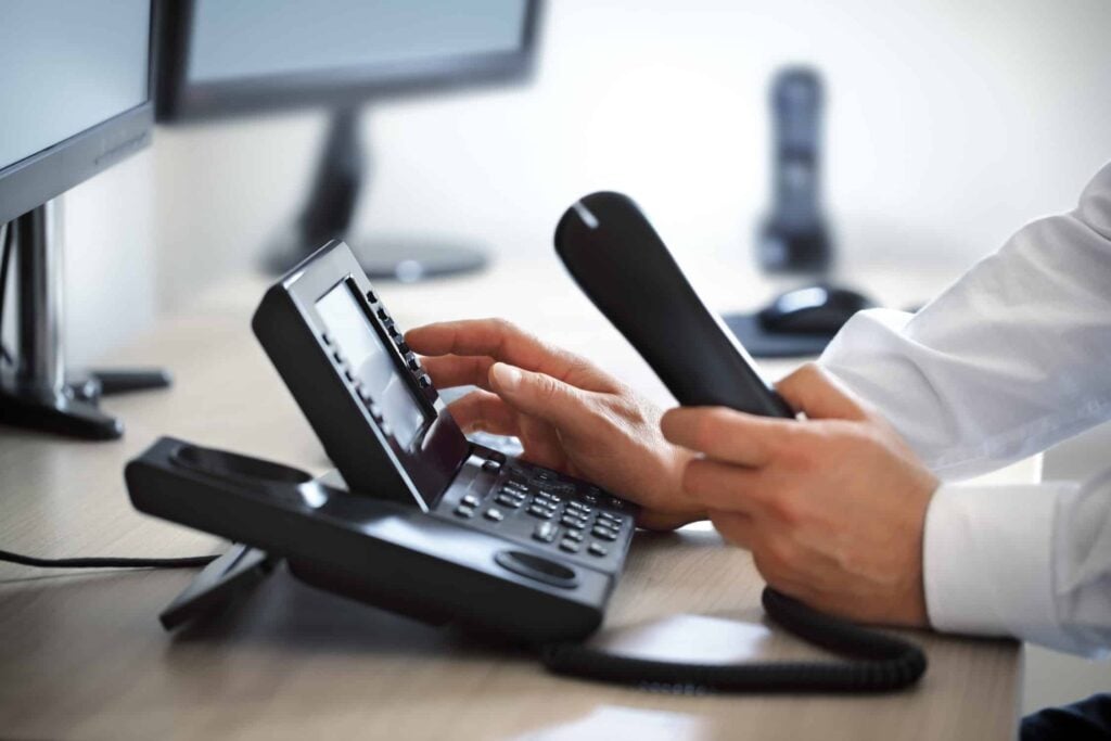 person dialing phone