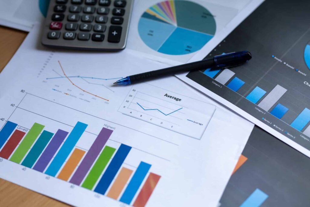 business chart with pen and calculator