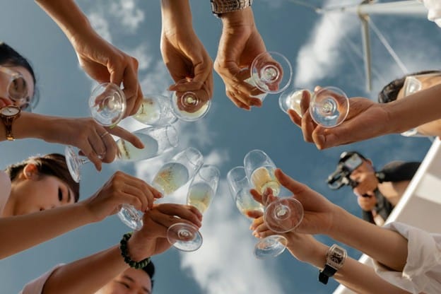 people holding up glasses