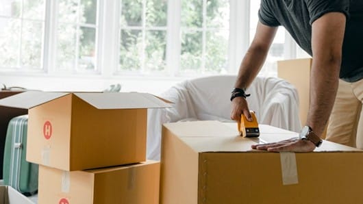 A professional preparing boxes on moving day