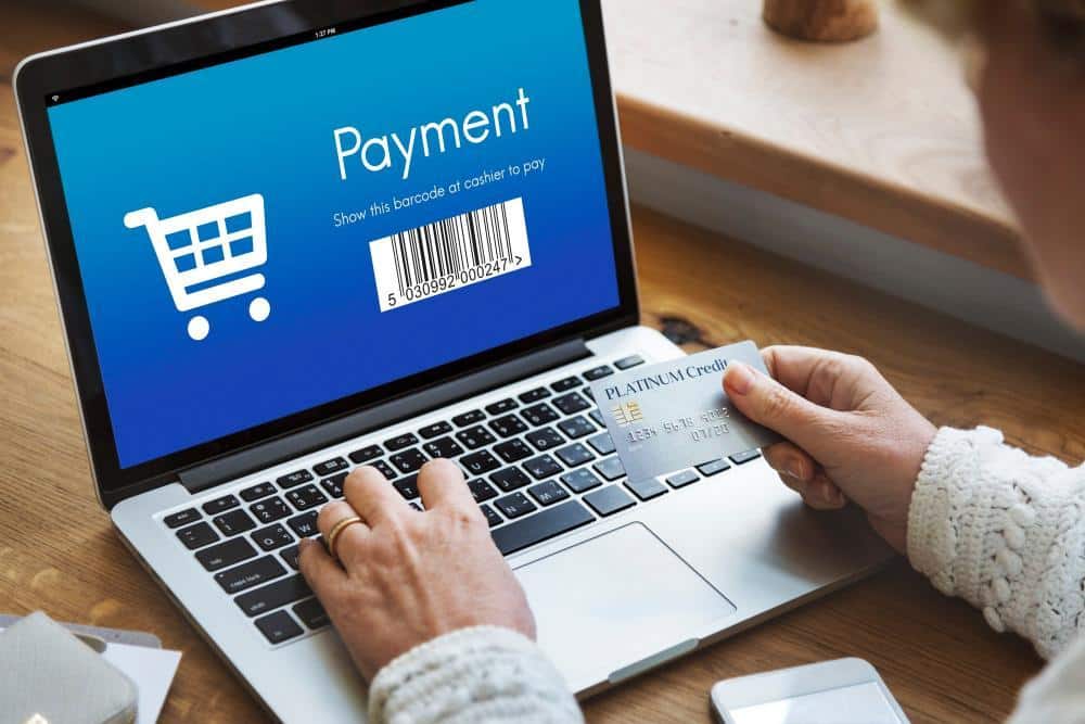 Person entering company card details on a laptop payment screen