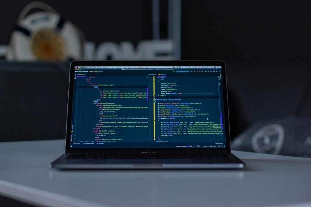 Laptop on a desk displaying code in an editor, representing API proxy configuration