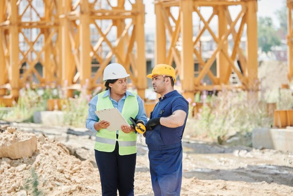A man and a woman working at a construction site